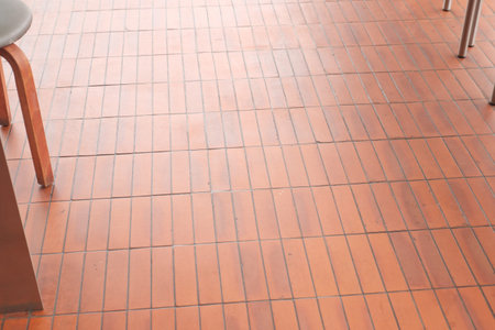 Floor with terracotta tiles and wooden chair in cafeの写真素材