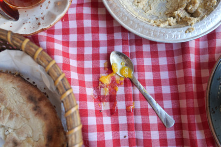 top view of food spilled on a red checkered tableclothの写真素材