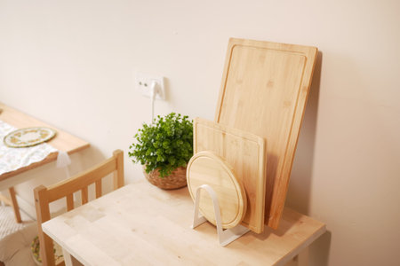 Cutting boards and plant on a kitchen table in a cozy home
