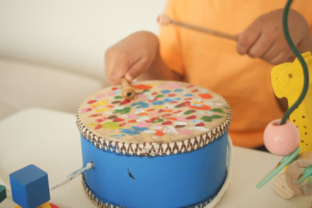 Child playing with colorful drum at home activityの写真素材