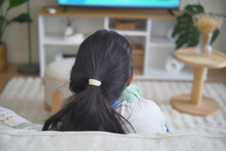 Girl watching television in cozy living room