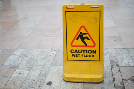 Caution sign indicating wet floor in busy area