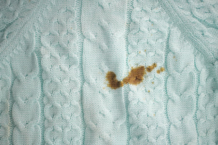 Stain on a light blue knitted sweater after a mealの写真素材