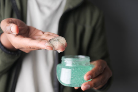 A person holds a small amount of hair gel in their hand.の写真素材