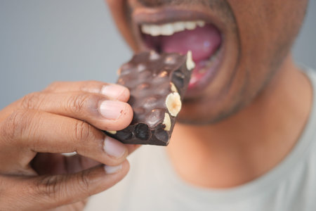 Enjoying a chocolate bar in a casual settingの写真素材