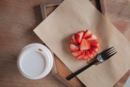 Strawberry dessert on a wooden tray with coffee nearbyの写真素材