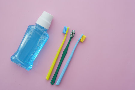 Important dental care items arranged on a pink backgroundの写真素材