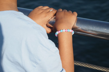 Child enjoys a sunny day by the water at the pier