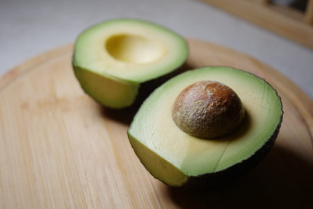 Freshly cut avocado displayed on a wooden board