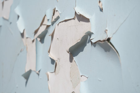 Peeling paint on a wall shows texture and aging charmの写真素材