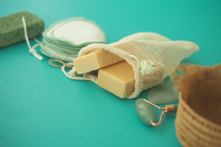 Natural skincare products arranged on a teal surfaceの写真素材