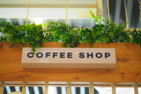 Cozy coffee shop with green plants in urban settingの写真素材