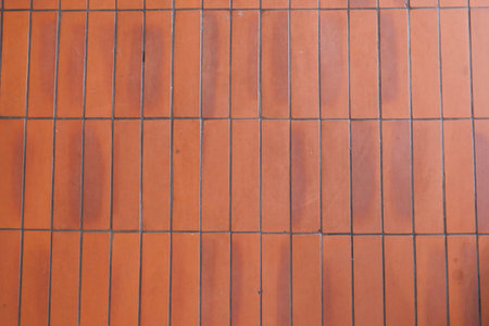 Floor made of orange terracotta tiles in a sunny setting