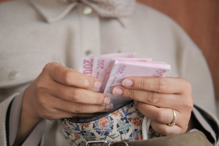 Counting money in a cozy indoor settingの写真素材