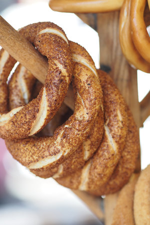 Freshly baked turkish simit hanging at a local marketの写真素材