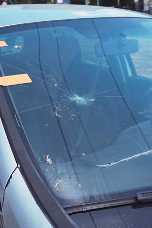 Cracked windshield in a parked car by the street