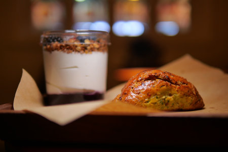 Breakfast treat with yogurt and pastry in cozy cafeの写真素材