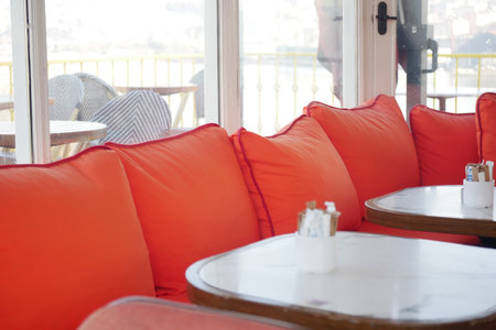 Cozy seating area in a vibrant cafe with bright cushionsの写真素材
