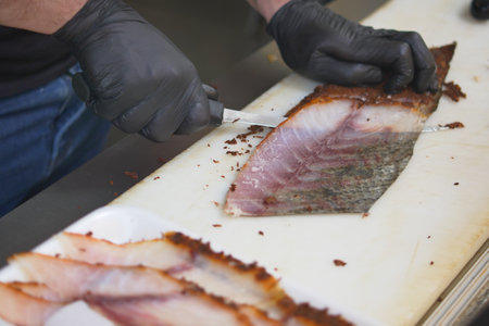 Chef preparing fish fillet with precision in a kitchenの写真素材