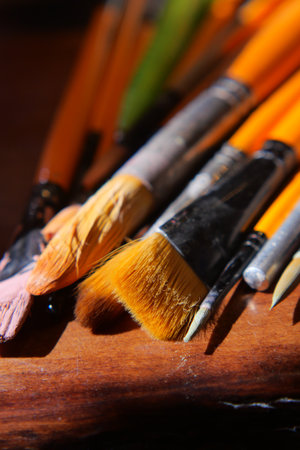 Brushes arranged on a wooden surface for painting activityの写真素材