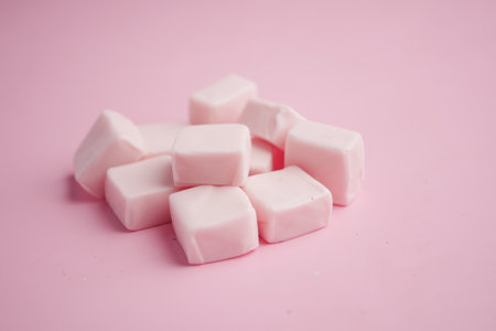 Pink chewing gum arranged on a pastel backgroundの写真素材