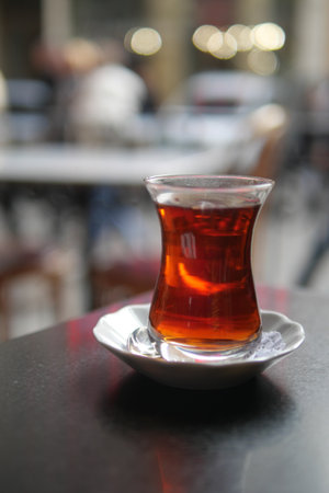 Warm turkish tea served on a small plate in a cafe settingの写真素材