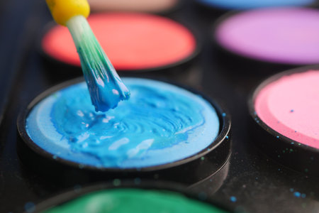 Engaging in vibrant painting with colors and brush techniqueの写真素材