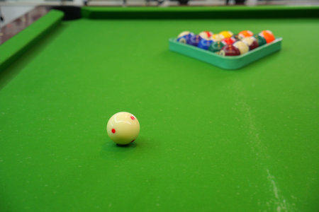 White cue ball on snooker table with colors behind