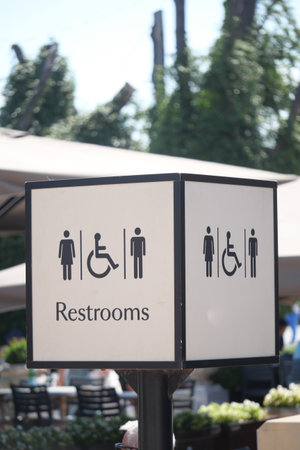 Clear restroom signage in a busy outdoor areaの写真素材