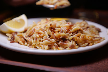 Delicious orzo pasta with lemon served on a plateの写真素材