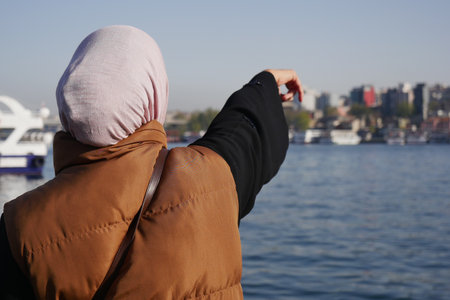 Woman enjoying the view by the waterfront in Istanbulの写真素材