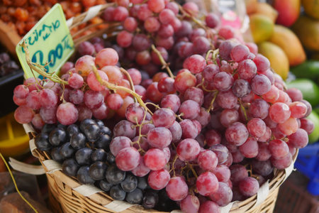 Fresh grapes in a woven basket at a local market