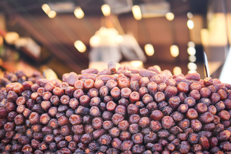 Dried dates at a bustling market in the afternoon sunの写真素材