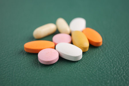 Assorted dietary supplements on a green surfaceの写真素材