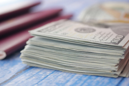 Stacks of cash and passports for travel preparationsの写真素材