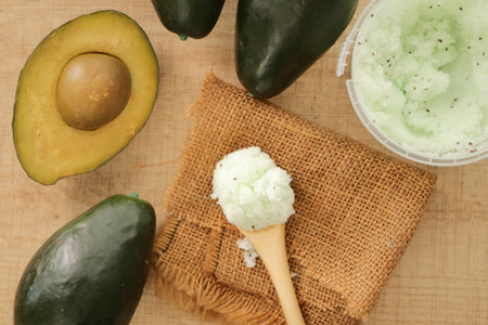 Fresh avocados and avocado scrub on a wooden spoonの写真素材