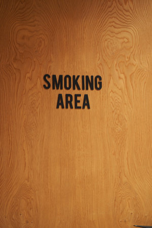 Design of a wooden door labeled as smoking areaの写真素材