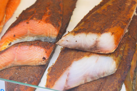 Freshly smoked salmon fillets displayed at a market