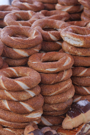 Freshly baked turkish simit stacked in a bakeryの写真素材