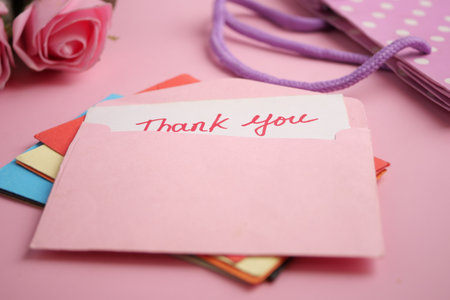 Thank you cards on a soft pink background with flowersの写真素材