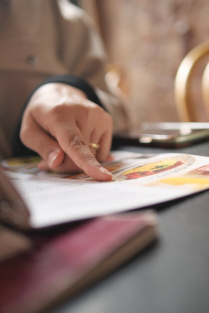 Choosing food options at a cozy restaurant tableの写真素材