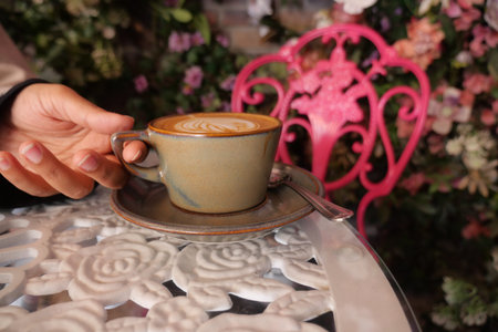 Enjoying coffee at a floral cafe setting in the afternoon