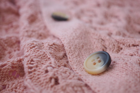 Pink fabric with buttons on textured surface