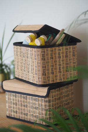 Craft supplies in organized boxes on a wooden table
