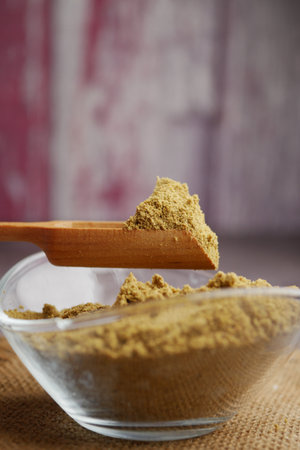 Spice collection in a bowl with wooden scoop for cookingの写真素材