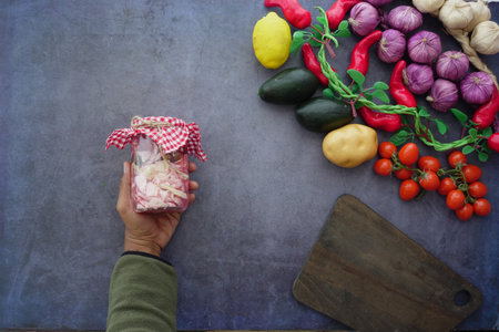 Colorful vegetables and pickled onions on kitchen tableの写真素材