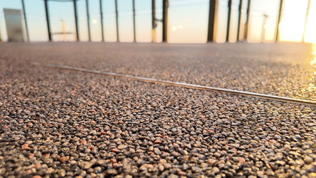 Sunset view from a rooftop terrace with textured flooringの写真素材