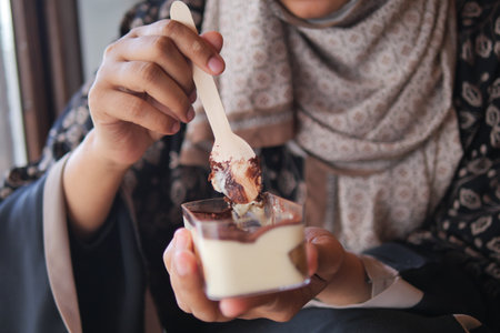 Enjoying dessert at a cozy cafe in the afternoonの写真素材