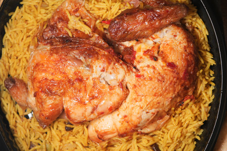 Juicy roasted chicken served with flavorful rice dishの写真素材