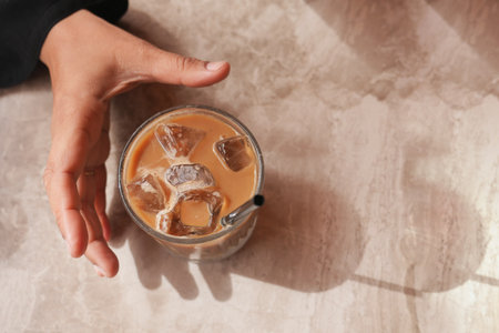 Refreshing iced coffee in a cozy cafe settingの写真素材